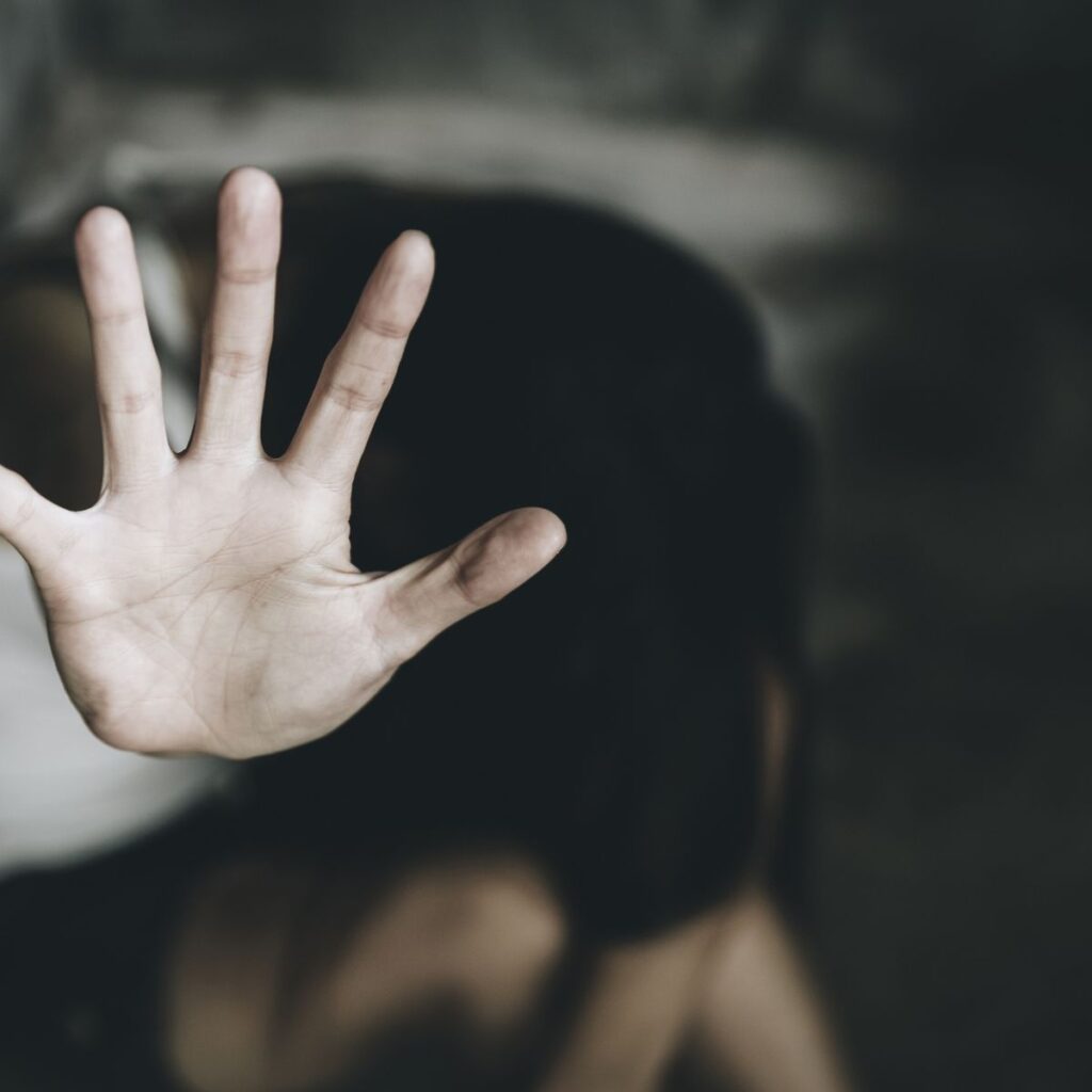 1 Close Up Of Woman Showing Stop Sign While Sitting Indoors
